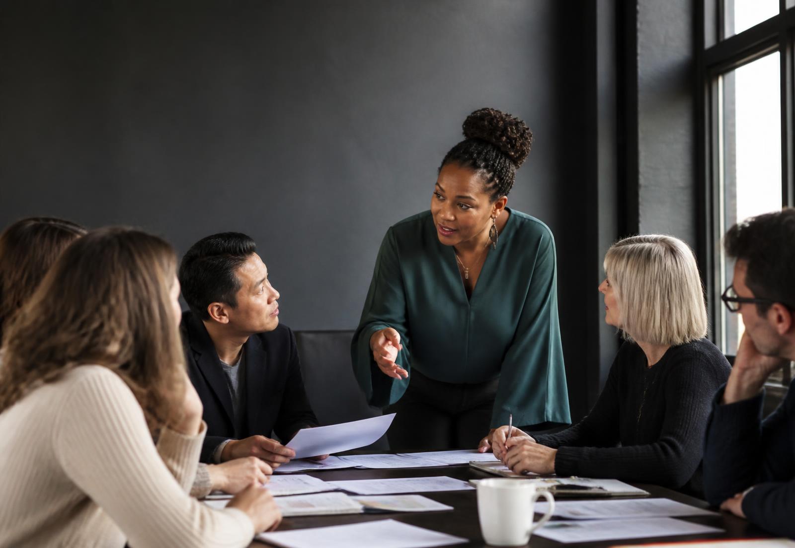 A facilitator leads educators in a collaborative review of learning materials